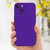 A hand holding a purple phone case with a blurred background of yellow flowers. Produktbild-Vorschau