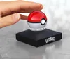 A hand is shown touching a Pokemon Pokeball replica that is lit up and sitting on a black display stand with the Pokemon logo. Náhľad obrázku produktu