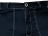 A close-up view of the waist area of dark blue work pants with prominent white stitching. Podgląd zdjęcia produktu