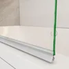 A close-up view of a shower screen attached to a bathtub. Produktbild-Vorschau