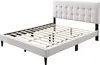A white upholstered bed frame with a tufted headboard and a wooden slat support system, shown from a diagonal side view. Náhľad obrázku produktu
