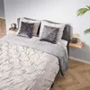 A bedroom scene with a bed, pillows, and a bedside table. Produktbild-Vorschau