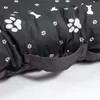 A close-up view of a dog bed with a paw print and bone pattern. Podgląd zdjęcia produktu