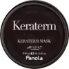 A close-up view of the lid of a dark-colored hair mask product. Náhled obrázku produktu