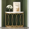 A modern console table with a marble top and gold metal frame, decorated with a bouquet of white flowers and a framed artwork. Podgląd zdjęcia produktu