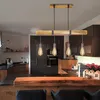 A modern kitchen with a wooden island and pendant lights. Anteprima dell’immagine prodotto