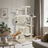 A multi-level cat tree with several cats interacting with it in a living room setting. Náhľad obrázku produktu