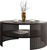 A round coffee table with a slatted base and a lower shelf, decorated with a vase of branches and two coffee cups. Náhľad obrázku produktu