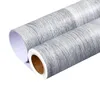 Two rolls of wood-effect adhesive wallpaper are shown against a white background. Náhľad obrázku produktu