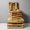 Stacked wooden crates against a gray wall and white surface. Produktbild-Vorschau