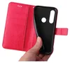 A hand holding a red flip phone case, showing the inside compartment. Produktbild-Vorschau