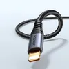 A close-up shot of a black braided audio cable with a Lightning connector, coiled into a loop. Náhled obrázku produktu