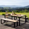 An outdoor dining set with a table and two benches on a wooden deck, with a scenic mountain landscape in the background. Produktbild-Vorschau