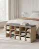 A storage bench with compartments and a cushion, placed in a bedroom in front of a bed. Náhled obrázku produktu