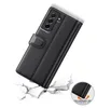 A black leather flip case for a smartphone is shown in a dynamic pose, appearing to be dropped onto a cracked surface, with a small inset showing a close-up of the case's corner protection. Produktbild-Vorschau