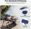 A woman relaxing on a blue sun lounger on a beach. Produktbild-Vorschau