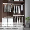 Interior view of a closet with clothes hanging on rods and drawers below. Produktbild-Vorschau