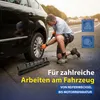 A man is kneeling on the side of a road, using a torque wrench to tighten the lug nuts on a car tire. A tool case is on the ground next to him. The image includes text and icons related to car maintenance. Anteprima dell’immagine prodotto