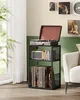 A record player stand with records and a speaker on it, placed next to a window and a sofa. Náhled obrázku produktu