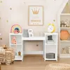 A child's desk and shelving unit in a room decorated with gold polka dots and a 'little princess' poster.