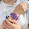 A person wearing a purple digital watch and a colorful beaded necklace. Produktbild-Vorschau
