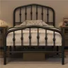 A black metal bed frame with a crown motif headboard is shown in a bedroom setting. Produktbild-Vorschau