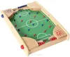A tabletop soccer game with red and blue player pieces and a silver ball on a green field. Produktbild-Vorschau