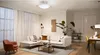 A well-lit living room with a sectional sofa, armchair, coffee table, and dining area. Podgląd zdjęcia produktu
