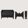 A black travel crib is shown in its assembled state and two folded states. Voir les images du produit
