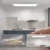 A modern kitchen with white cabinets and a sleek LED ceiling light panel. Produktbild-Vorschau