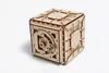 A wooden 3D puzzle in the shape of a safe is shown against a white background. Produktbild-Vorschau