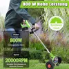 A person is using a green electric string trimmer in a garden. Produktbild-Vorschau