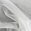 A close-up view of white sheer fabric, likely a curtain or veil, with folds and texture visible. Náhľad obrázku produktu
