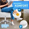 A woman is sitting on a white rolling stool, reading a book. The image highlights product features like comfort, easy cleaning, and water-repellent surface. Podgląd zdjęcia produktu