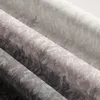 Close-up view of rolled-up fabric with a plant pattern. Produktbild-Vorschau