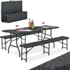 A black folding picnic table and bench set is displayed, set up for a meal with wine bottles and glasses. Produktbild-Vorschau