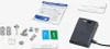 A collection of sewing machine accessories and an instruction manual are laid out on a white background. Voir les images du produit