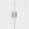 A close-up view of two white cabinet doors with black handles. Voir les images du produit