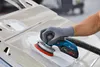 A person is using a Bosch sander on a car door. Anteprima dell’immagine prodotto