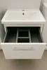A white bathroom vanity cabinet with a sink and an open drawer. Produktbild-Vorschau