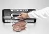 A person is using a vacuum sealer to package meat. Produktbild-Vorschau