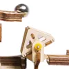 A close-up view of a wooden marble run mechanism with a metal ball. Náhľad obrázku produktu