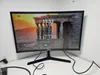 A Samsung monitor is displayed on a white desk against a white wall. Produktbild-Vorschau