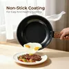 A hand is holding a frying pan over a plate of food, with eggs sliding out of the pan onto the plate. Produktbild-Vorschau