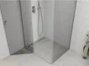 A modern corner shower enclosure with glass panels and a concrete-look shower tray. Podgląd zdjęcia produktu