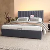 A bedroom scene with a bed as the main focus, featuring a headboard with integrated charging ports and a tablet. Anteprima dell’immagine prodotto
