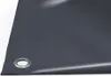 A close-up view of a dark grey PVC tarpaulin with a metal grommet. Náhled obrázku produktu