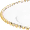 A close-up view of the rim of a clear glass plate with a decorative gold beaded edge. Produktbild-Vorschau