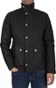 A man wearing a black jacket and blue jeans. Produktbild-Vorschau