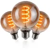 Three vintage-style LED light bulbs with spiral filaments, arranged in a cluster on a white background. Produktbild-Vorschau